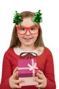 Isolated on white portrait of a cute little girl in funny red glasses and green shiny christmas trees on springs. She wear in red Royalty Free Stock Photo