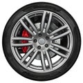 Isolated on white sport car wheel with metallic spoke rim, shine black tire, red disk brake. New clean car wheel disign element