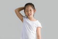 Asian Child Scratching Head and Smiling with White T-Shirt, Isolated on White, Studio Shot