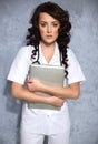 Woman doctor carrying a laptop Royalty Free Stock Photo