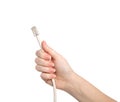 Isolated woman hand holding computer cable