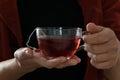 Isolated woman hand holding a cup of hot red tea, white background Royalty Free Stock Photo