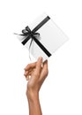 Isolated Woman Hands holding Holiday Present White Box with Dark Black Ribbon on a White Background Royalty Free Stock Photo