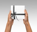 Isolated Woman Hands holding Holiday Present White Box with Grey Ribbon on a White Background Royalty Free Stock Photo