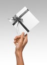 Isolated Woman Hands holding Holiday Present White Box with Grey Ribbon on a White Background Royalty Free Stock Photo