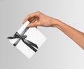 Isolated Woman Hands holding Holiday Present White Box with Grey Ribbon on a White Background Royalty Free Stock Photo