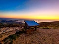 Isolated wooden board on a grassy hilltop overlooking a sun-kissed ocean view in Portugal Royalty Free Stock Photo