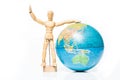 Isolated wooden figure with globe on white background Royalty Free Stock Photo