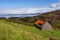 Isolated wooden hut situated on the edge of a steep mountain in Drumbeg, Scotland Royalty Free Stock Photo