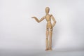 Isolated wooden jointed manikin doll standing on solid background