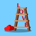 Isolated wooden stepladder with red letters love and hearts