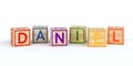 Isolated wooden toy cubes with letters with name daniel