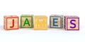 Isolated wooden toy cubes with letters with name james