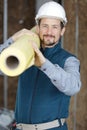 isolated worker carrying insulation roll Royalty Free Stock Photo