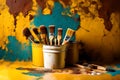 Isolated yellow paint bucket with painting brushes infront of solid color rusty wall, texture, HD background.