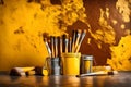 Isolated yellow paint bucket with painting brushes infront of solid color rusty wall, texture, HD background. Royalty Free Stock Photo