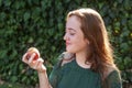 Isolated young woman holding a some cherries in her hands. Big red cherries with leaves and stalks. One person on the background. Royalty Free Stock Photo