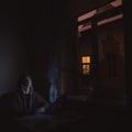 Isolation and night working of middle age person programmer with laptop at home, night time artistic foreshortening