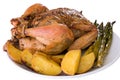 Isoloated roasted whole chicken on a plate Royalty Free Stock Photo