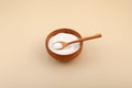Isomalt or Isomaltitol powder in wooden bowl. Food additive E963, sweetener. Isomalt, sugar substitute, a type of sugar alcohol.