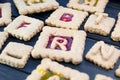 Isomalt stained glass cookies with letters. Christmas or X-mas baking culinary background, cooking recipe Royalty Free Stock Photo