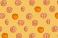 Isomertic food pattern with fresh ripe whole and parted mandarine on a bright yellow background