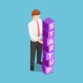 Isometric businessman arranging blocks with the word STARTUP