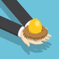 Isometric businessman holding nest with golden egg. Royalty Free Stock Photo