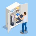 Isometric large wardrobe with things. Man choosing outfit from large wardrobe closet with clothes and home stuff