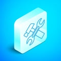 Isometric line Crossed hammer and wrench spanner icon isolated on blue background. Hardware tools. Silver square button