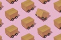 Isometric pattern with cardboard boxes on wheels as trucks Royalty Free Stock Photo