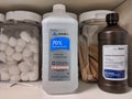 Isopropyl alcohol and hydrogen peroxide in a medical cabinet with cotton balls