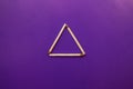 Isosceles triangle on a bright background. matchstick pyramid on cardboard. Education concept