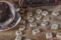 Isoteric concept of divination and prediction. Runes, coffee grounds in a cup, rosary on a table against the background Royalty Free Stock Photo