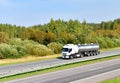 Isothermal Tank truck driving on highway. Oil and Gas Transportation and Logistics. Metal chrome cistern tanker with