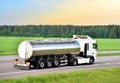 Isothermal Tank truck driving on highway. Oil and Gas Transportation and Logistics. Metal chrome cistern tanker with Royalty Free Stock Photo