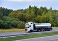 Isothermal Tank truck driving on highway. Oil and Gas Transportation and Logistics.