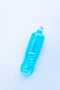 isotonic drink, blue sport energy beverage in bottle on heavenly background Vertical