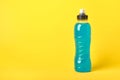 Isotonic energy blue transparent sport drink in plastic bottle on yellow background Royalty Free Stock Photo