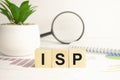 isp sign on wooden cubes and magnifier Royalty Free Stock Photo