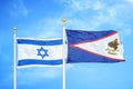 Israel and American Samoa two flags on flagpoles and blue cloudy sky Royalty Free Stock Photo