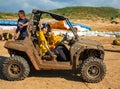 Rally off-road buggy covered in dirt covered and happy passengers in Arsuf coast