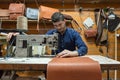 Israel based male leather artisan making custom leather bags in a small shop in old city of Jerusalem, Israel