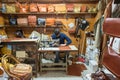 Israel based male leather artisan making custom leather bags in a small shop in old city of Jerusalem, Israel