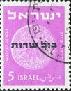 Israel circa 1951: A post stamp printed in Israel showing a coin with service stamps