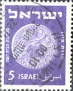 Israel circa 1949: A post stamp printed in Israel showing a coin with a vine leaf