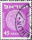 Israel circa 1952: A post stamp printed in Israel showing a coin with Bunch of Grapes
