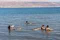 Israel, Dead Sea, 11-05-2019 View of people who float weightlessly on the blue salt water of the Dead Sea. Royalty Free Stock Photo