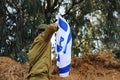 Israel Defense Forces IDF concept: Israeli soldier salutes the flag of Israel