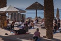 Group of people of different ages, from different countries doing yoga on the Red Sea beach